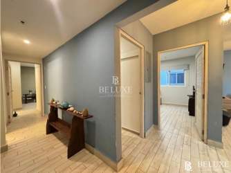 Master bedroom with queen-size bed, AC, and garden views at Playa Caracol condo Panama