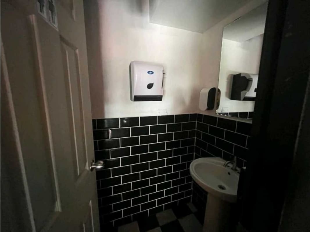 Wood steps, black walls, wood panel railing of staircase commercial unit PH Plaza 50 Panama City