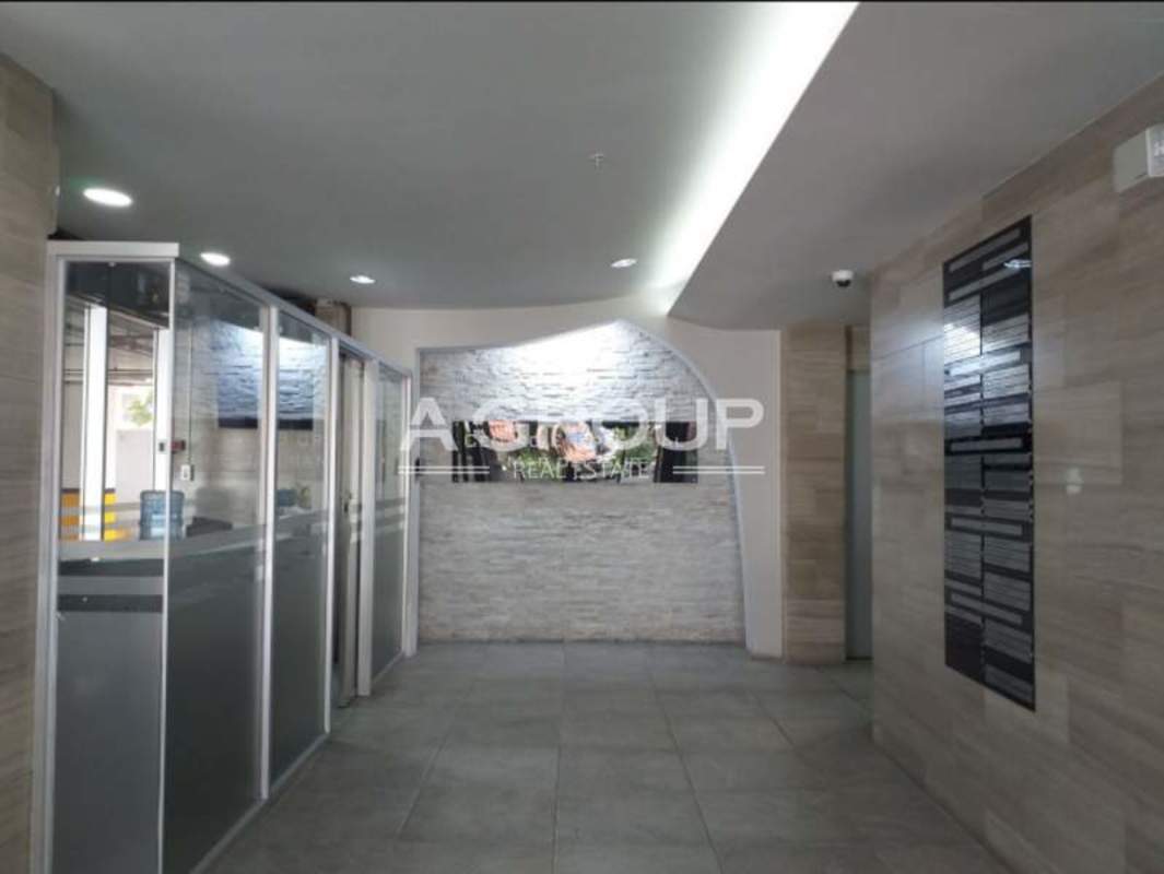 Office lobby with glass walls stone accents directory board Centro Empresarial Mar del Sur Bella Vista Panama