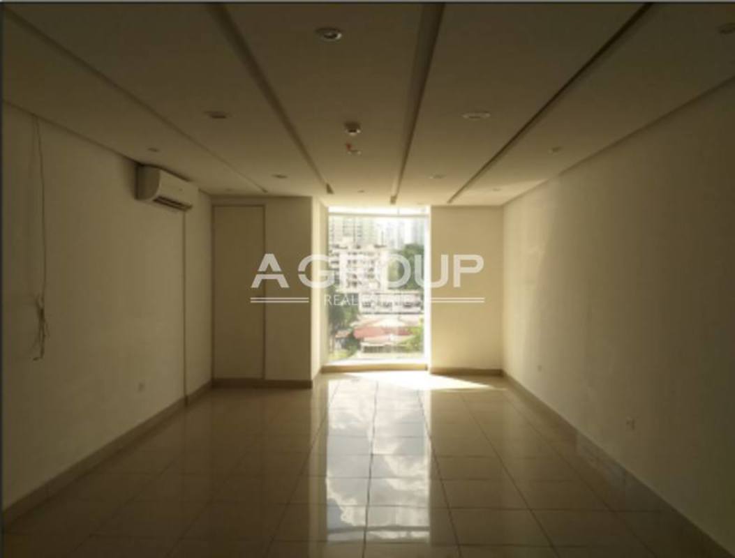 Empty office interior space with large window tiled floors white walls Centro Empresarial Mar del Sur