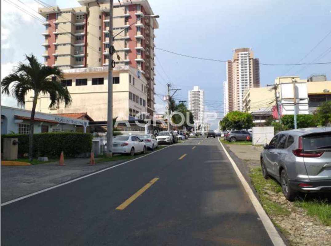 Urban street with high-rise buildings and palm tree Centro Empresarial Mar del Sur Panama City