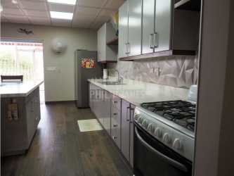 Kitchen with island marble countertops modern cabinetry open plan Panama