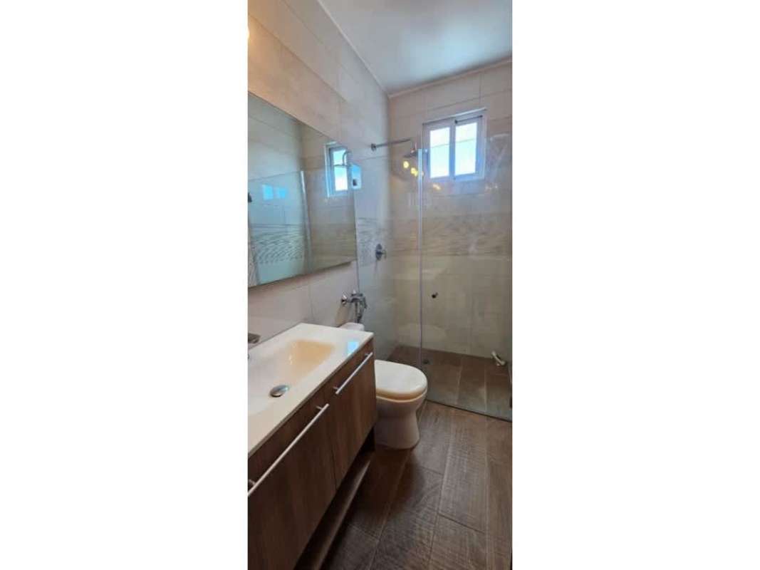 Updated bathroom with glass-enclosed shower, mirror, vanity, window in PH Dinasty Towers Bella Vista Panama