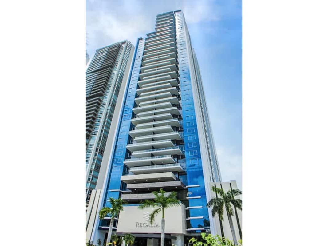 Open-plan kitchen with white cabinetry, stainless steel appliances in Costa del Este luxury apartment
