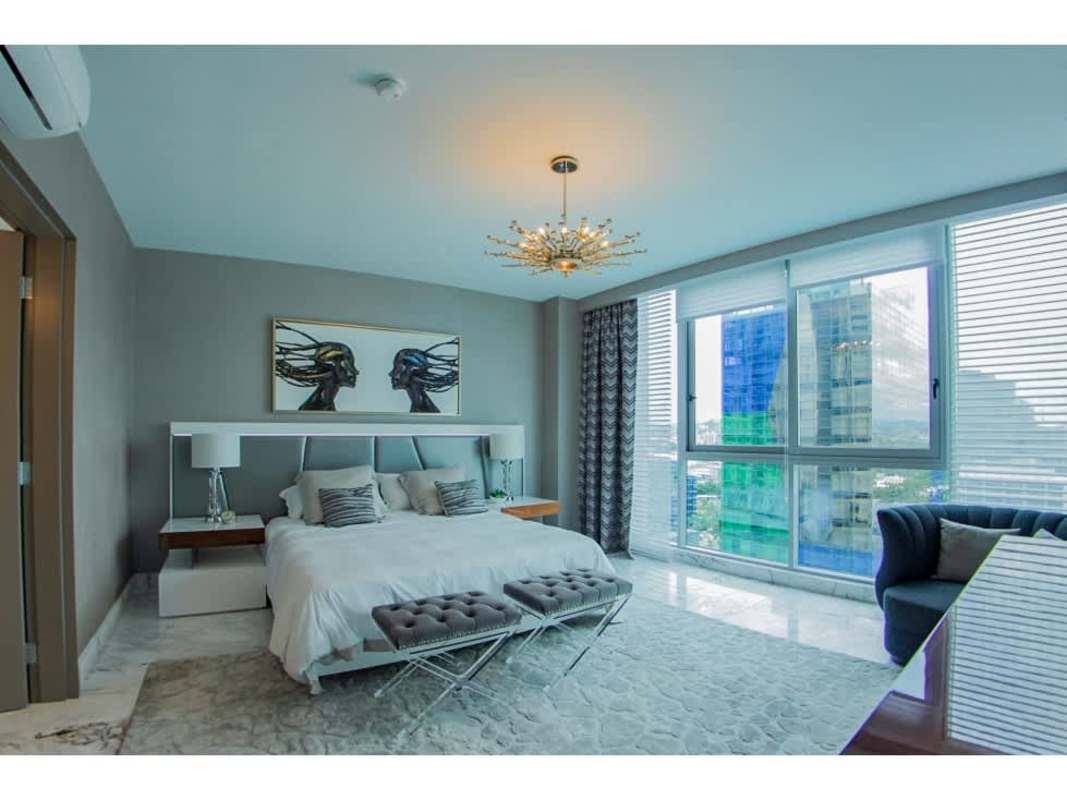 Modern balcony with city and ocean view, stylish white furniture in PH Regalia Costa del Este