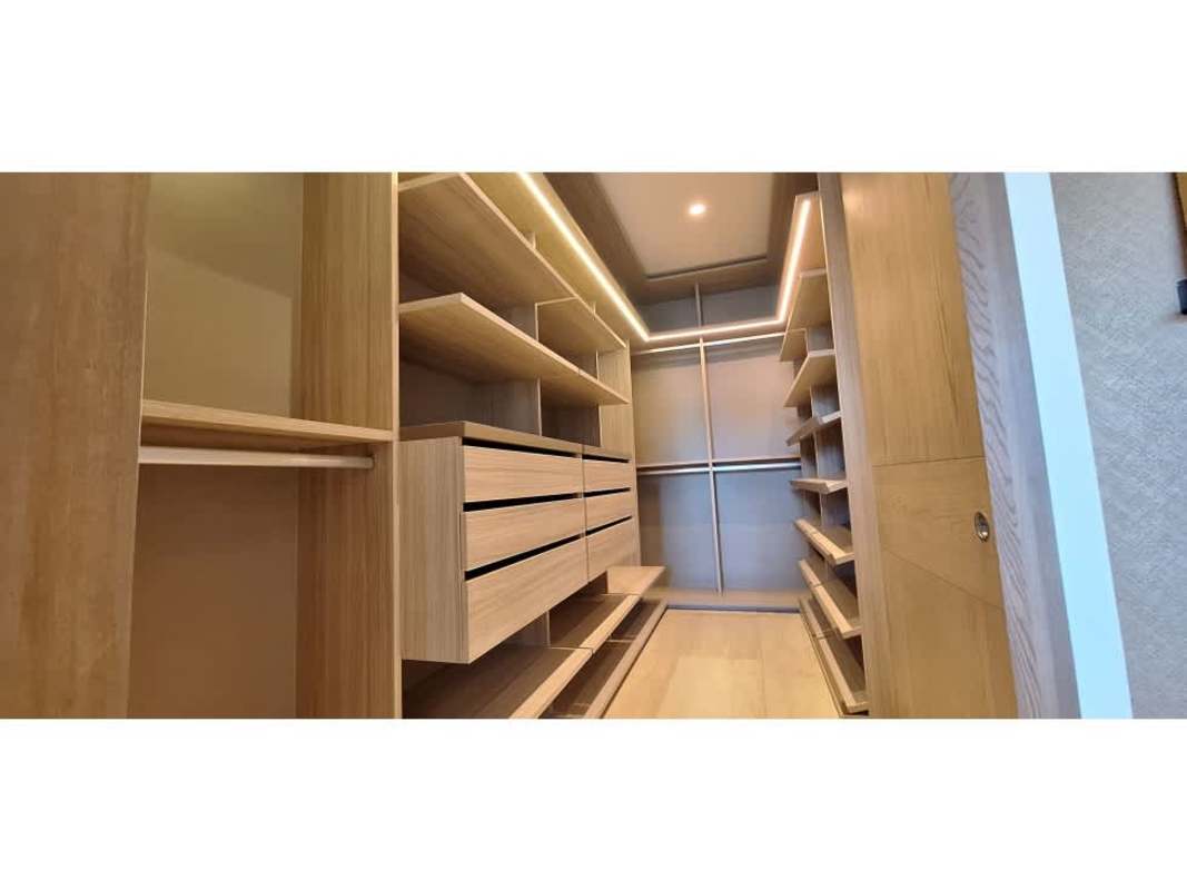Elegant bathroom with floating double sink vanity, glass-enclosed shower and beige tiling at The Woods Santa Maria