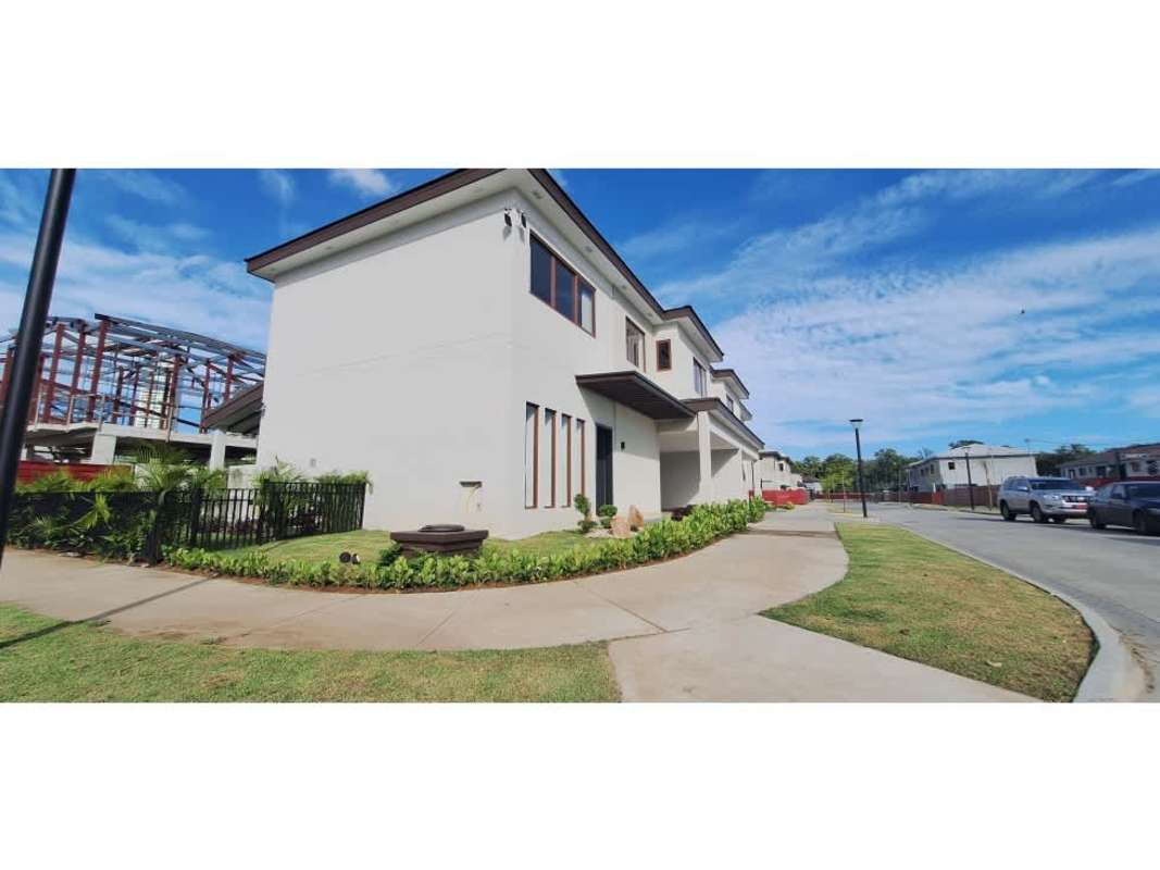 Custom modern walk-in closet with built-in wood cabinets and recessed lighting at The Woods Santa Maria