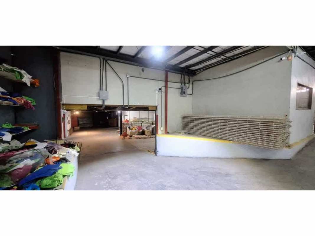 Warehouse interior with loading dock, metal shelving units, and industrial lighting Betania Panama