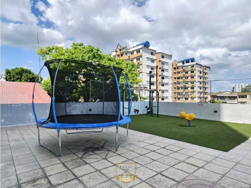 Rooftop playground with trampoline and play equipment at PH Prisma Panama City