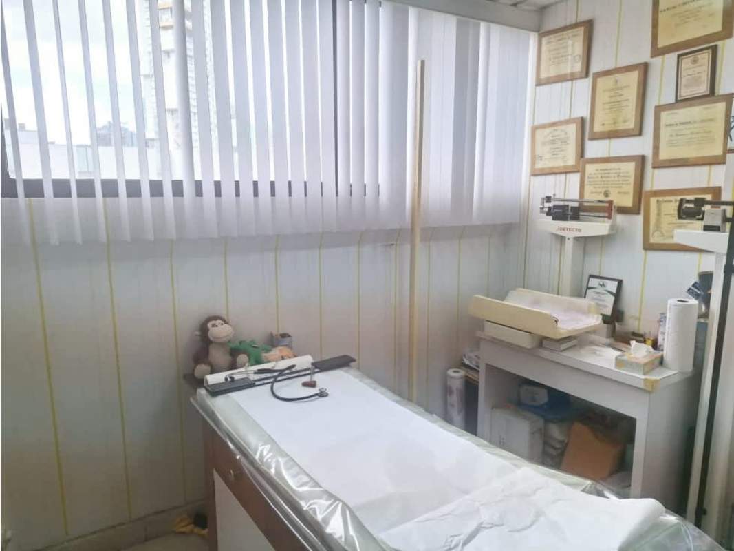 Modern commercial building exterior view with glass facade and palm trees Consultorios Paitilla Panama City