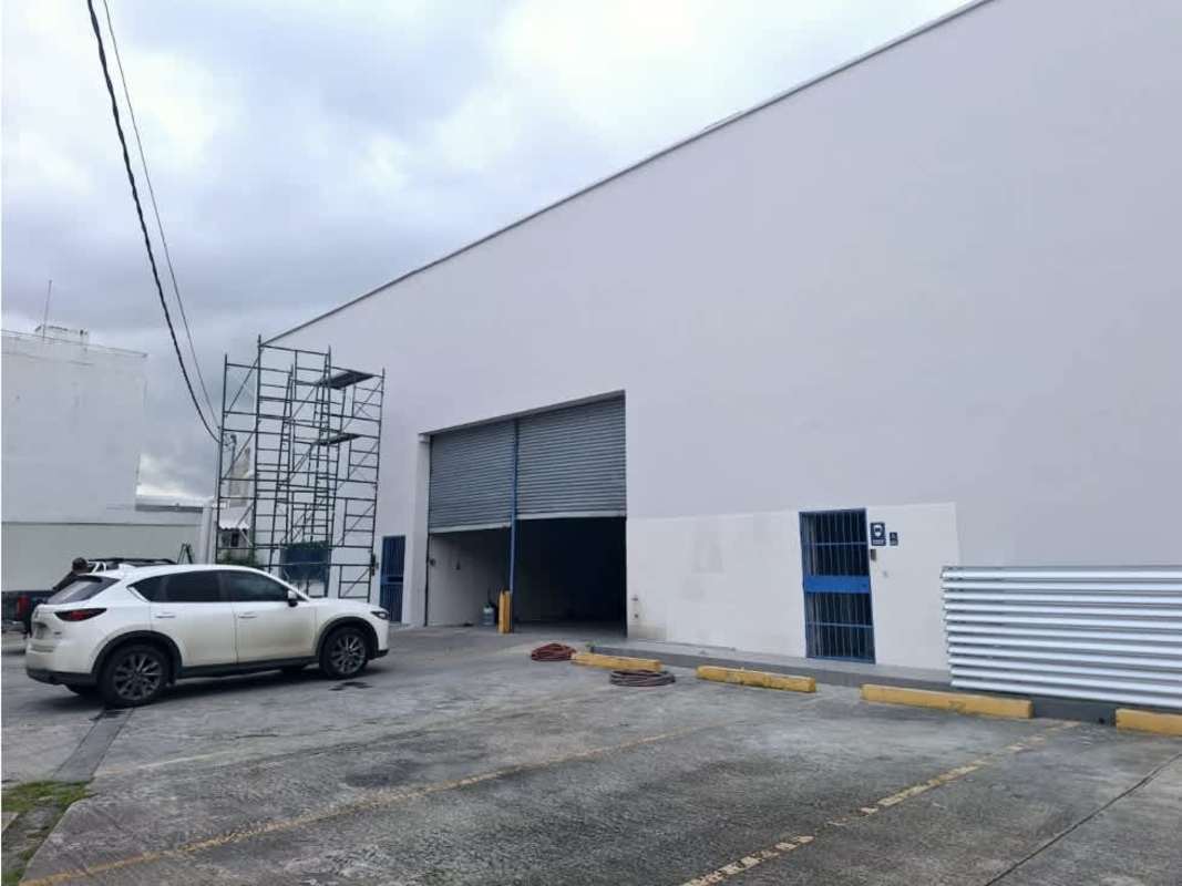 Secure entrance with parking spaces and large industrial doors at Costa del Este warehouse Panama City