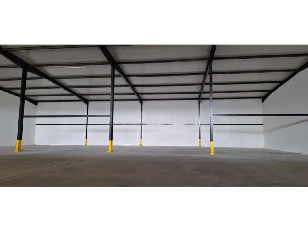 Warehouse interior view with high clearance steel beams reinforced structure in Pacora Panama