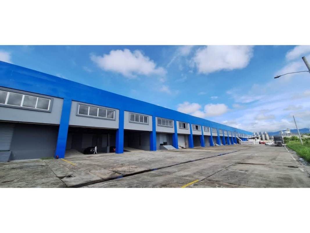 Exterior view industrial warehouse blue gray facade loading docks Pacora Panama