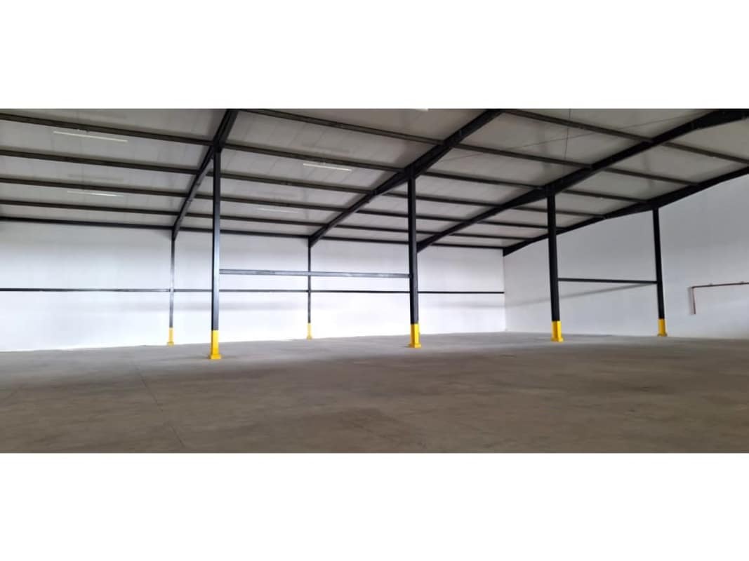 Empty interior of warehouse with steel supports concrete floor in Parque Industrial Pacora Panama