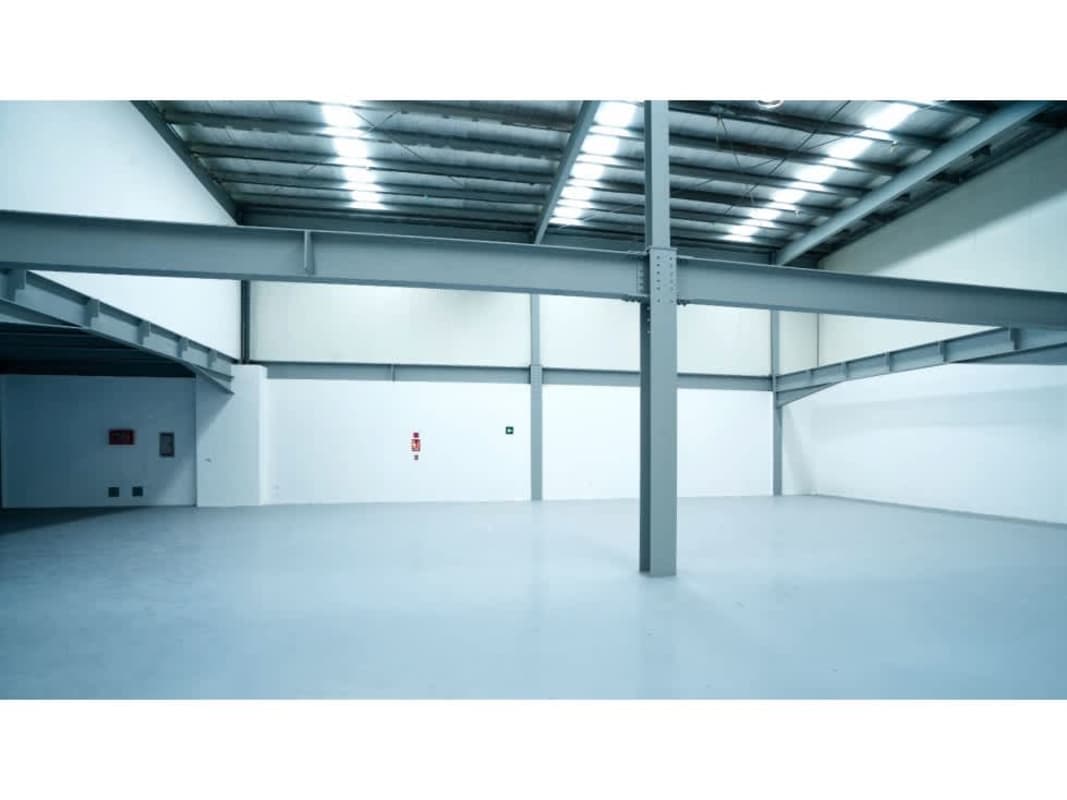 Warehouse interior featuring high ceiling with steel beams, open layout at Panama Business Center