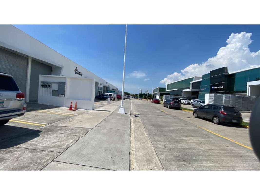 Exterior view modern warehouses parking lot palm trees at Panama Business Center Chanis Panama City