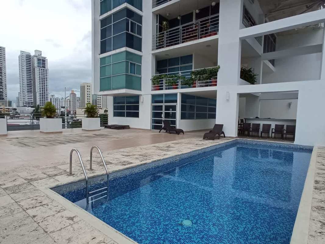 Swimming pool with sun loungers and city view at PH Famagosta Loft Panama