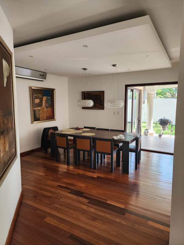 Dining room with wood flooring, pendant lights, patio views Costa del Este residence
