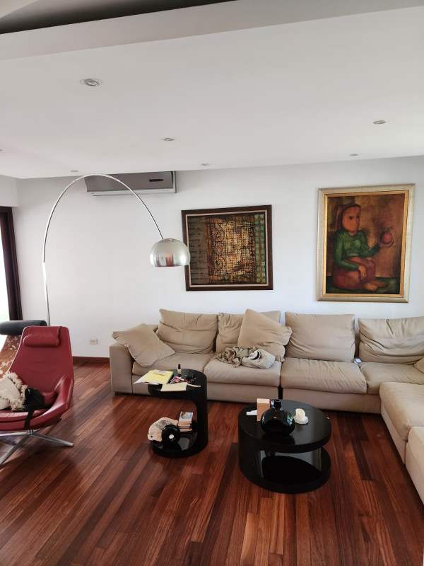 Large living area with sectional sofa, AC, modern arc lamp Costa del Este Panama