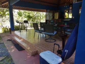 Covered patio with BBQ area, hammocks ideal for outdoor entertaining at Las Lajas beach rental Panama
