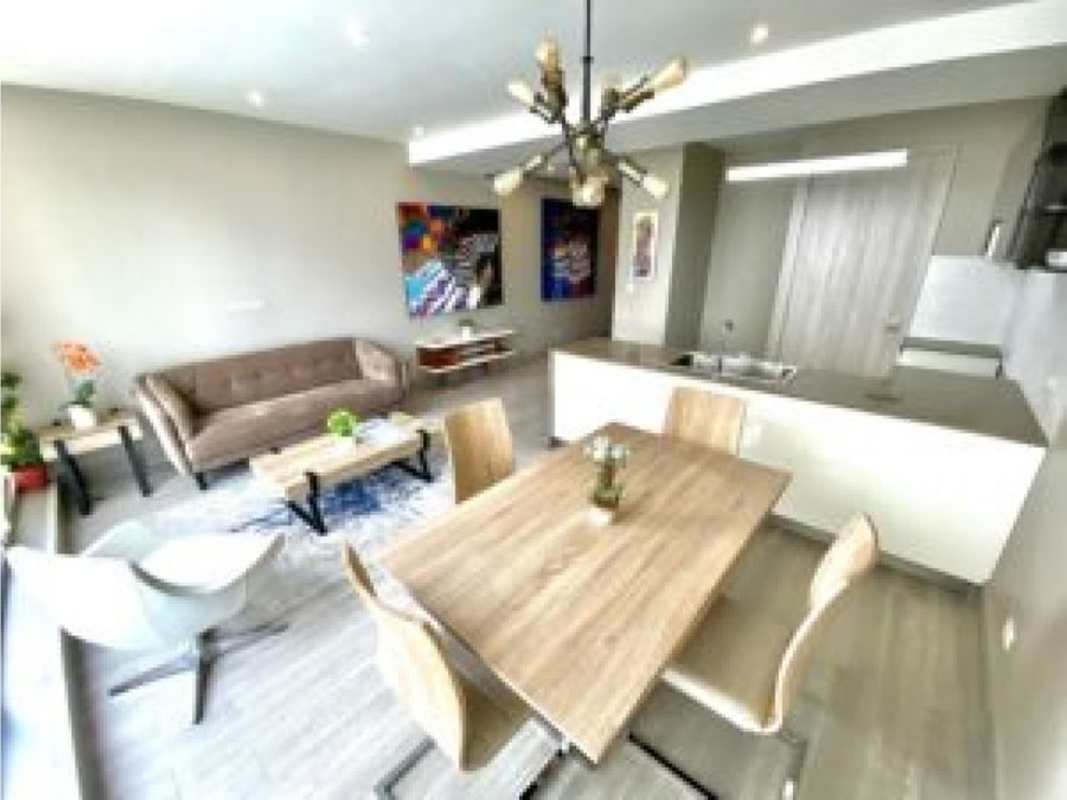 Dining area with modern lighting and balcony views in Panama City Bella Vista apartment