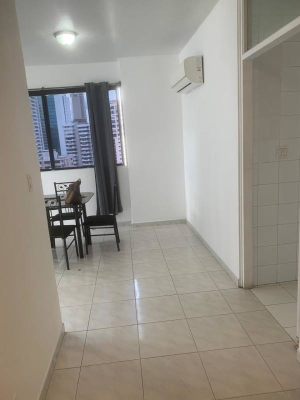 Empty living room with tiled floor, large window, AC unit and curtains PH Marble Tower Panama