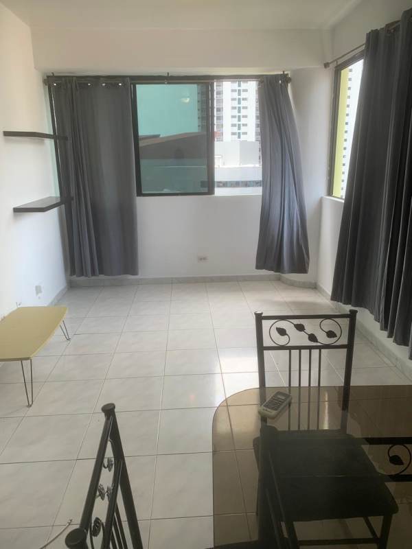 Minimalist dining space with large window, city skyline view in PH Marble Tower Panama