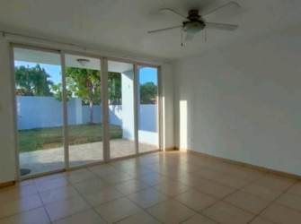 Living room space with tile floor, large window, sliding glass doors to patio Costa Verde Panama house