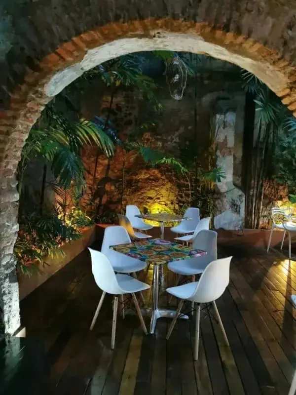 Indoor rustic dining with plants and arch Casco Viejo colonial restaurant Panama