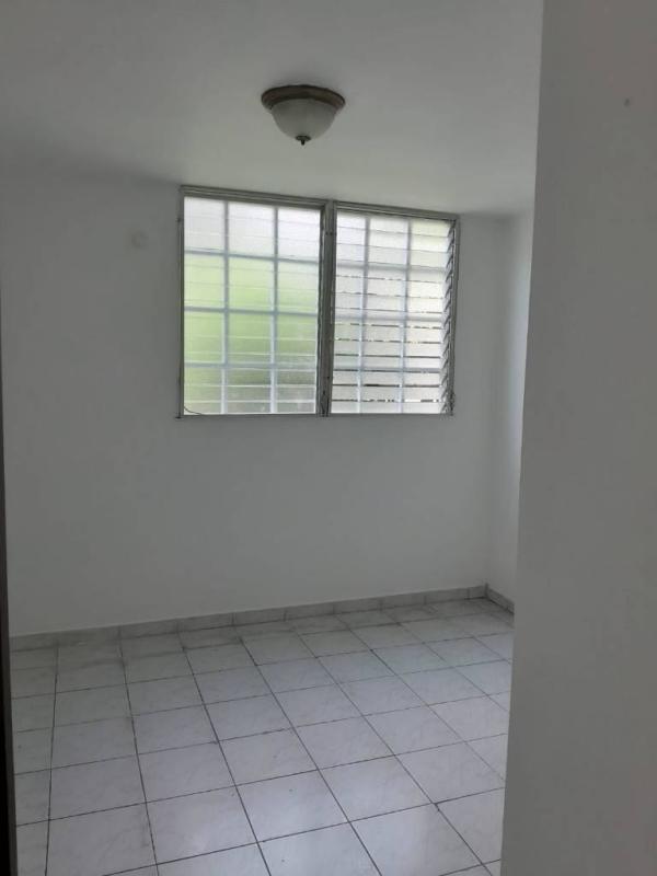 Bright bathroom with shower, bidet sprayer and simple tile finish Panama rental apartment