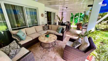 Outdoor covered patio dining area with tile floors and garden view at Royal Decameron Panama