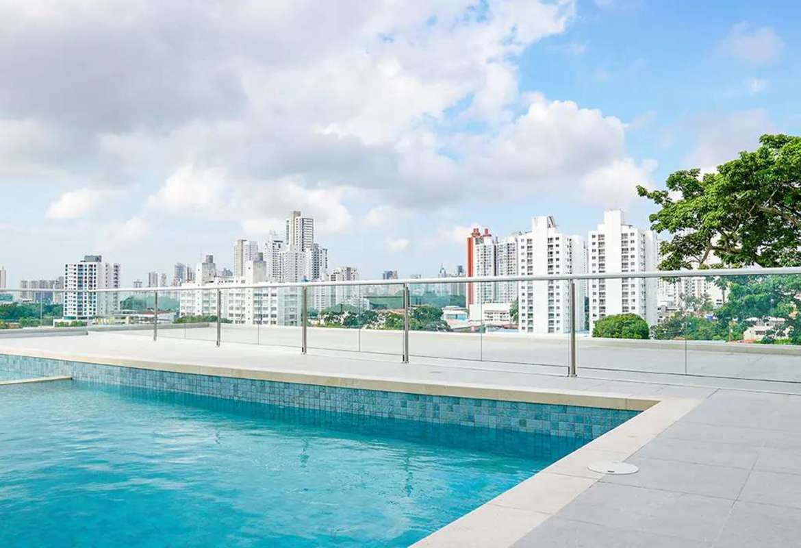 Modern rooftop swimming pool with glass railing city skyline panorama PH T7 Panama City
