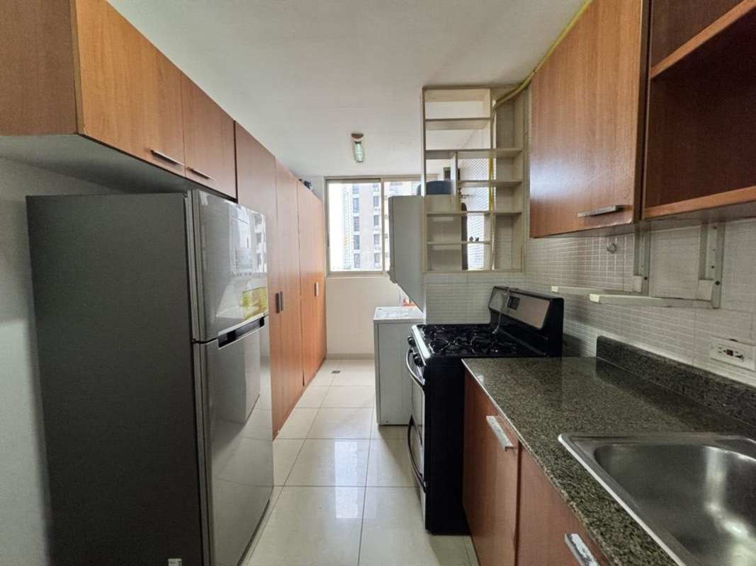 Kitchen with granite countertops, wood cabinetry, tile backsplash and appliances PH San Francisco Bay Panama City