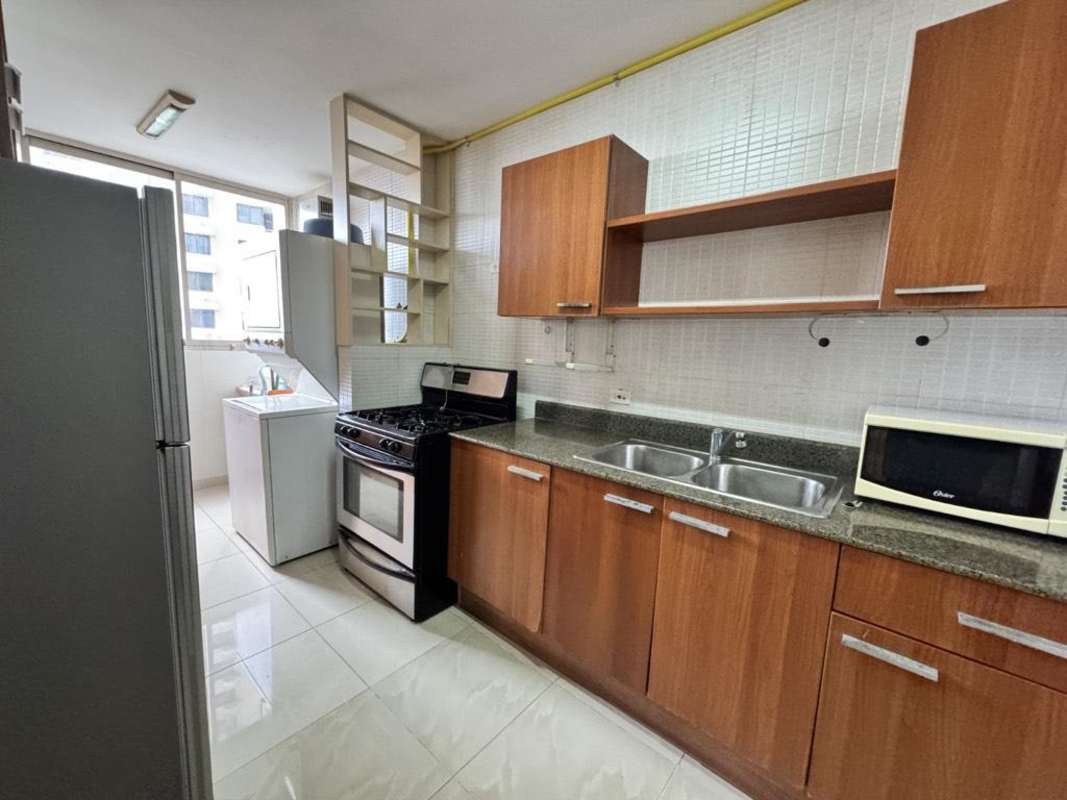 Contemporary kitchen with granite countertops, gas stove, appliances and window Panama City