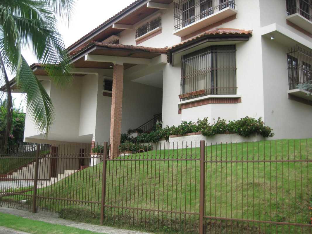 Elegant foyer with marble flooring, chandelier, arched double doors, staircase in Altos de Golf Panama house