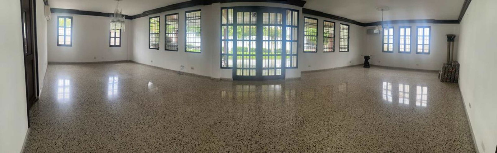 Small powder bathroom with pedestal sink, floral tile accents, mirror in Altos de Golf residence Panama
