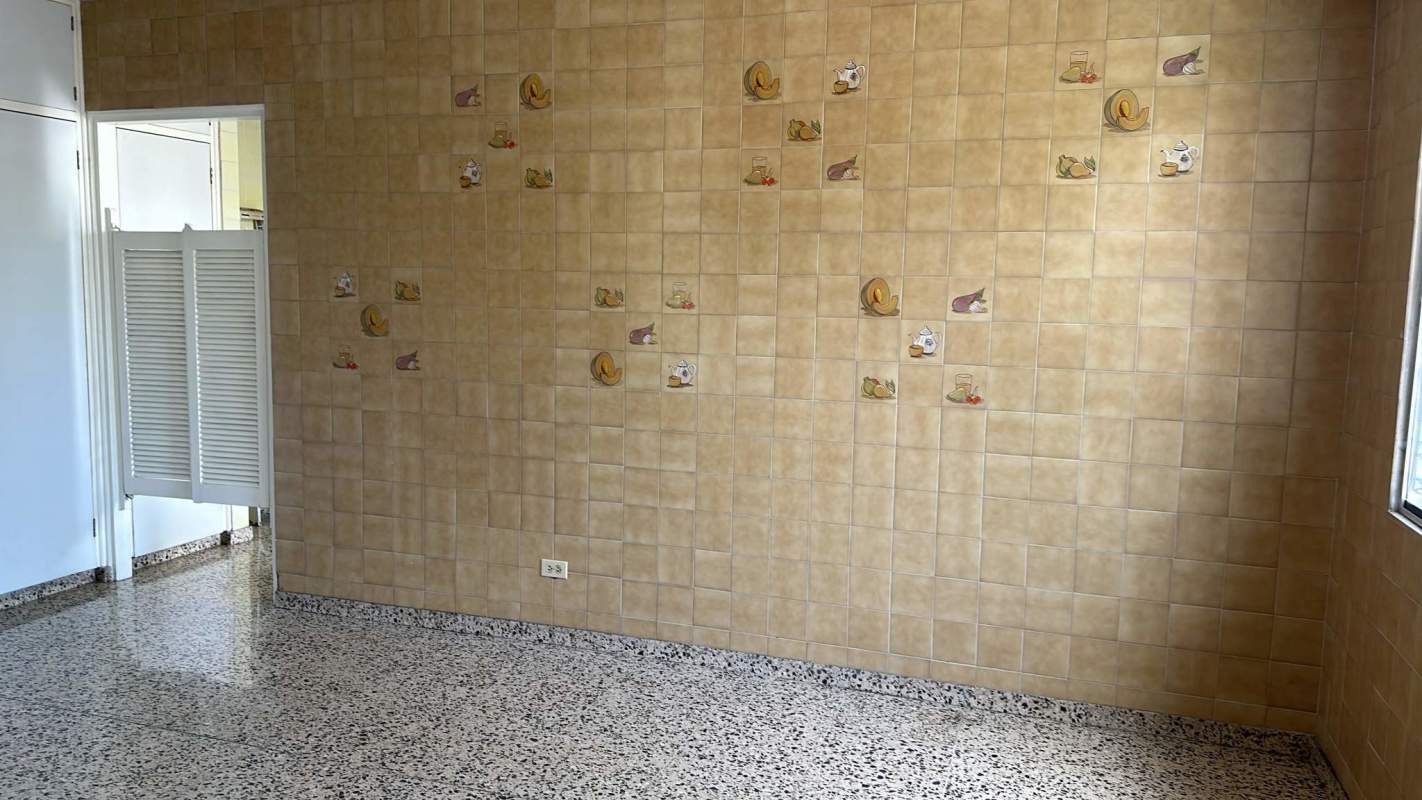 Vintage kitchen ceramic tiled walls, terrazzo floor, decorative tile accents at Altos de Golf family house Panama