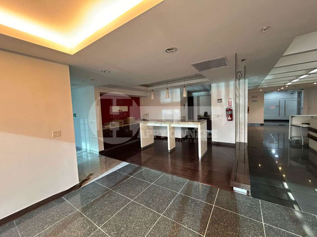 Office corridor with polished granite floor, recessed lighting glass walls PH Torres de Las Americas Panama City