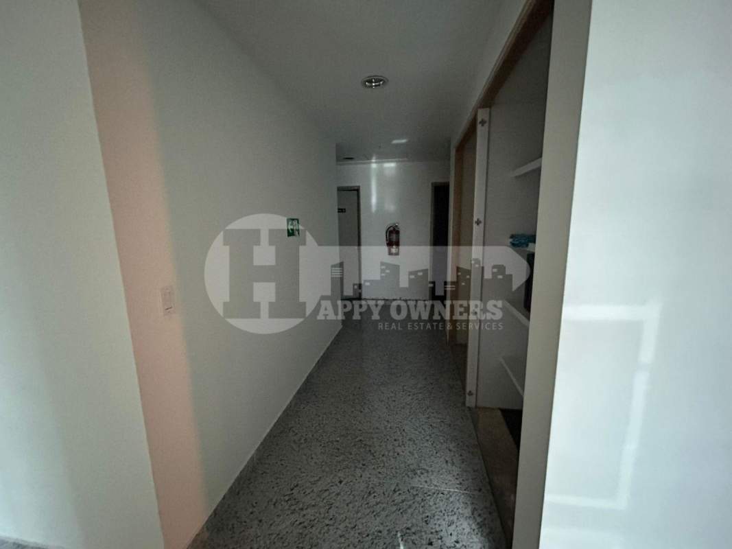 Minimalist hallway in office tower granite flooring recessed lighting PH Torres de Las Americas Panama