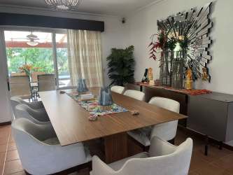 Contemporary kitchen with granite countertops and stainless appliances Royal Decameron townhome Panama