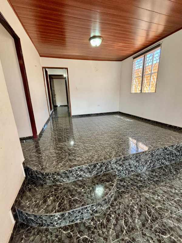 Covered backyard terrace with marble patterned floor tiles Las Mañanitas home Panama