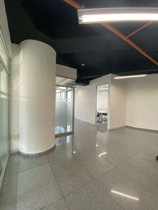 Modern conference room with large windows, oval table, executive chairs, panoramic views in El Tornillo Panama