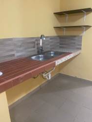 Kitchen with double sink, shelves, tiled backsplash in furnished studio Santiago Panama