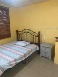 Metal frame bed and simple decor in studio rental Santiago Panama
