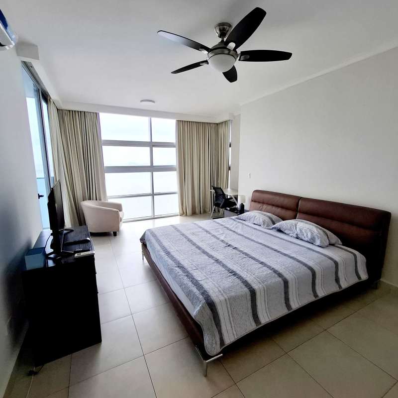 Spacious master bedroom with king bed, ocean views, large windows in PH Waters Panama