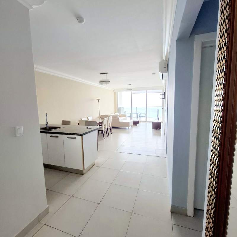 Modern living and dining area with large windows and balcony access in PH Waters Panama