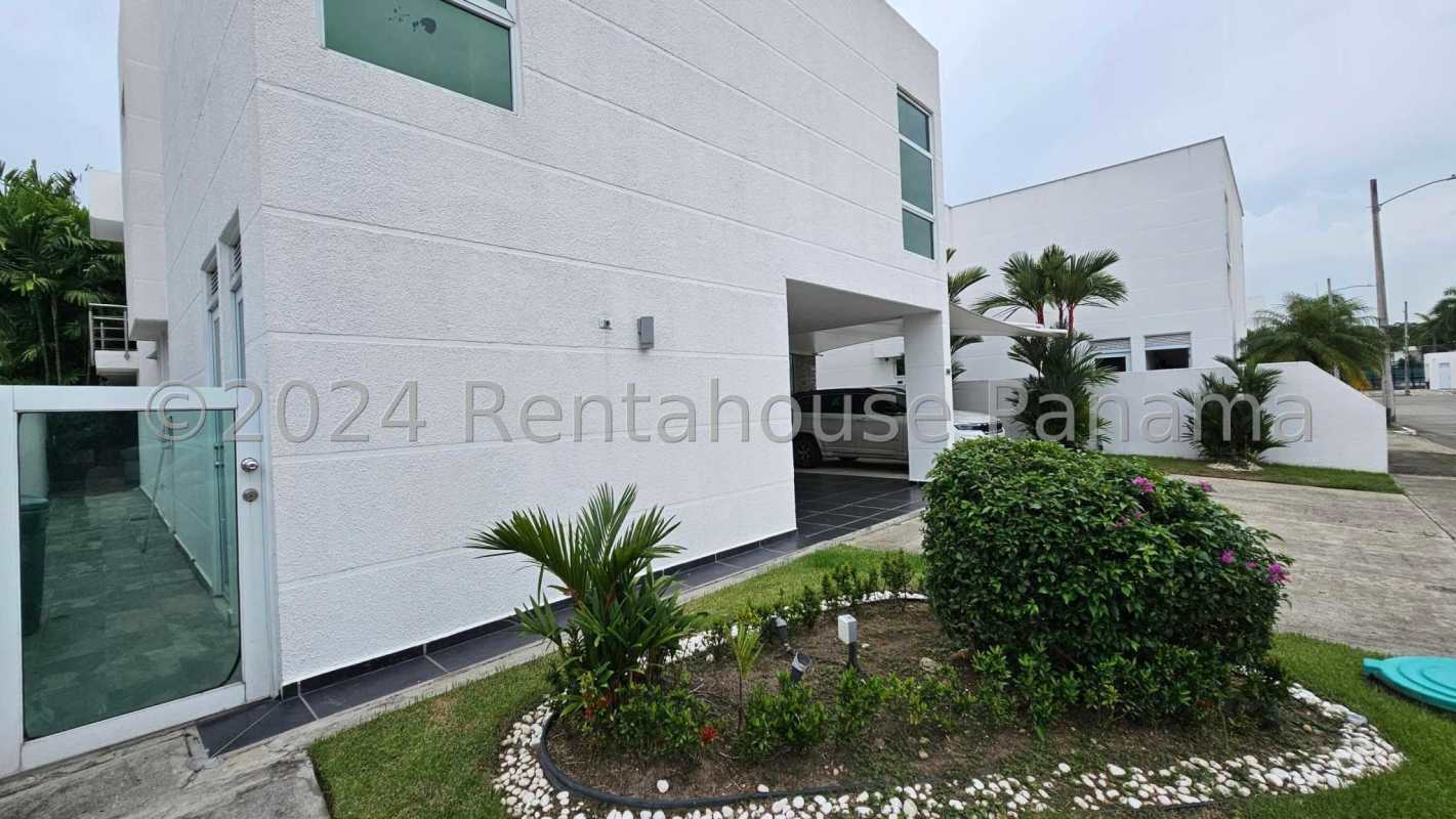 Modern kitchen in Costa Sur house with granite island, stainless appliances, wooden cabinetry