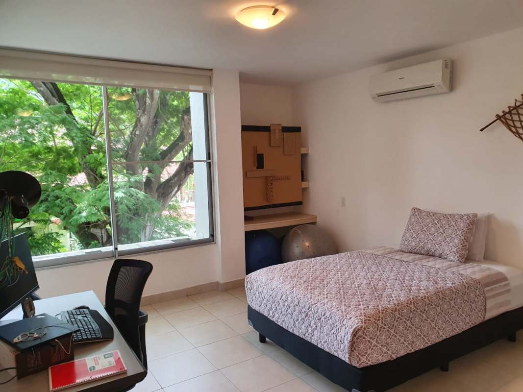 Bedroom with large window, AC, workspace desk overlooking trees Ciudad del Saber Clayton Panama