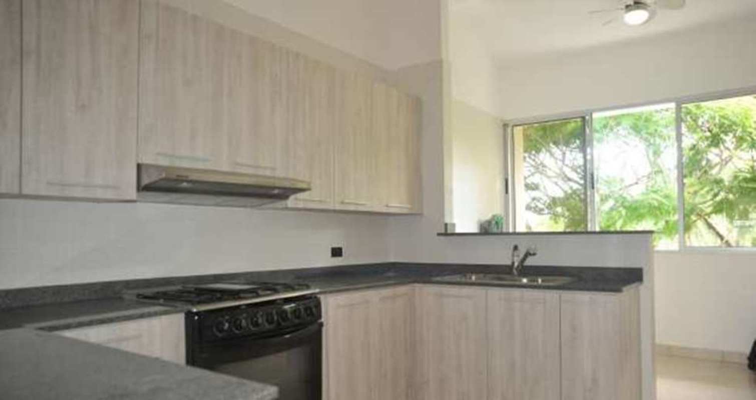 Outdoor dining area on balcony with ceiling fan and lush views Ciudad del Saber Clayton Panama