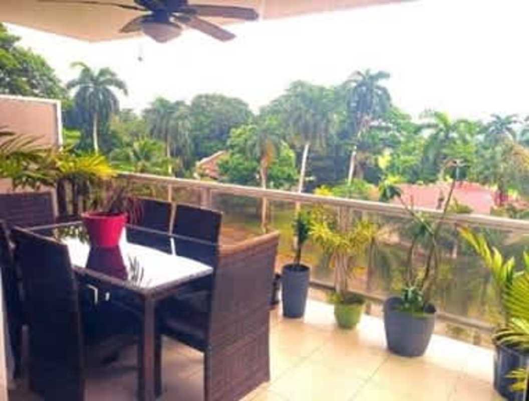 Modern kitchen with light wood cabinets, built-in stove, dishwasher, garden view Ciudad del Saber Panama